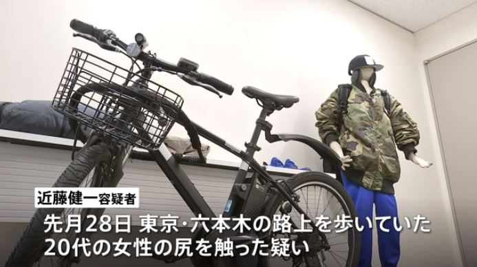 A man on a black bicycle, arrested for touching a woman's buttocks in Roppongi late at night. (JNN)